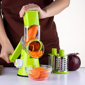 Green round vegetable mandoline slicer with julienne drum and collection bowl