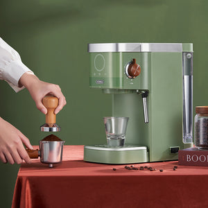 Green home coffee maker with portafilter, drip tray, and control panel.