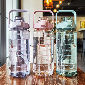 Set of three large plastic water bottles with cup lids and carrying handles