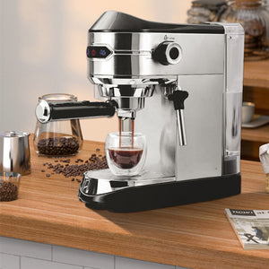 Silver semi-automatic steam wand milk frother with cup under dispensing spout